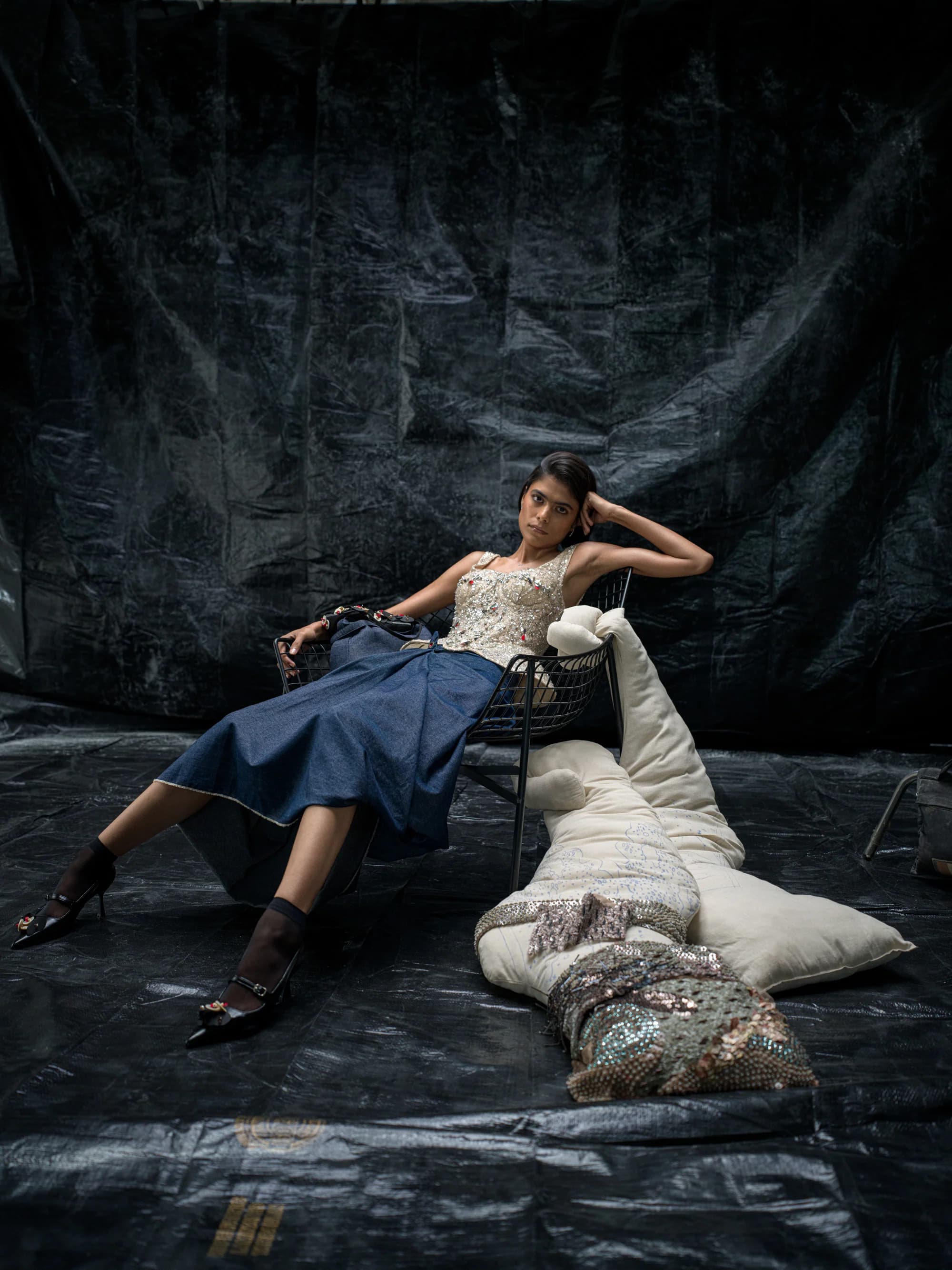 Striped outerwear portrait framed by garden stonework.