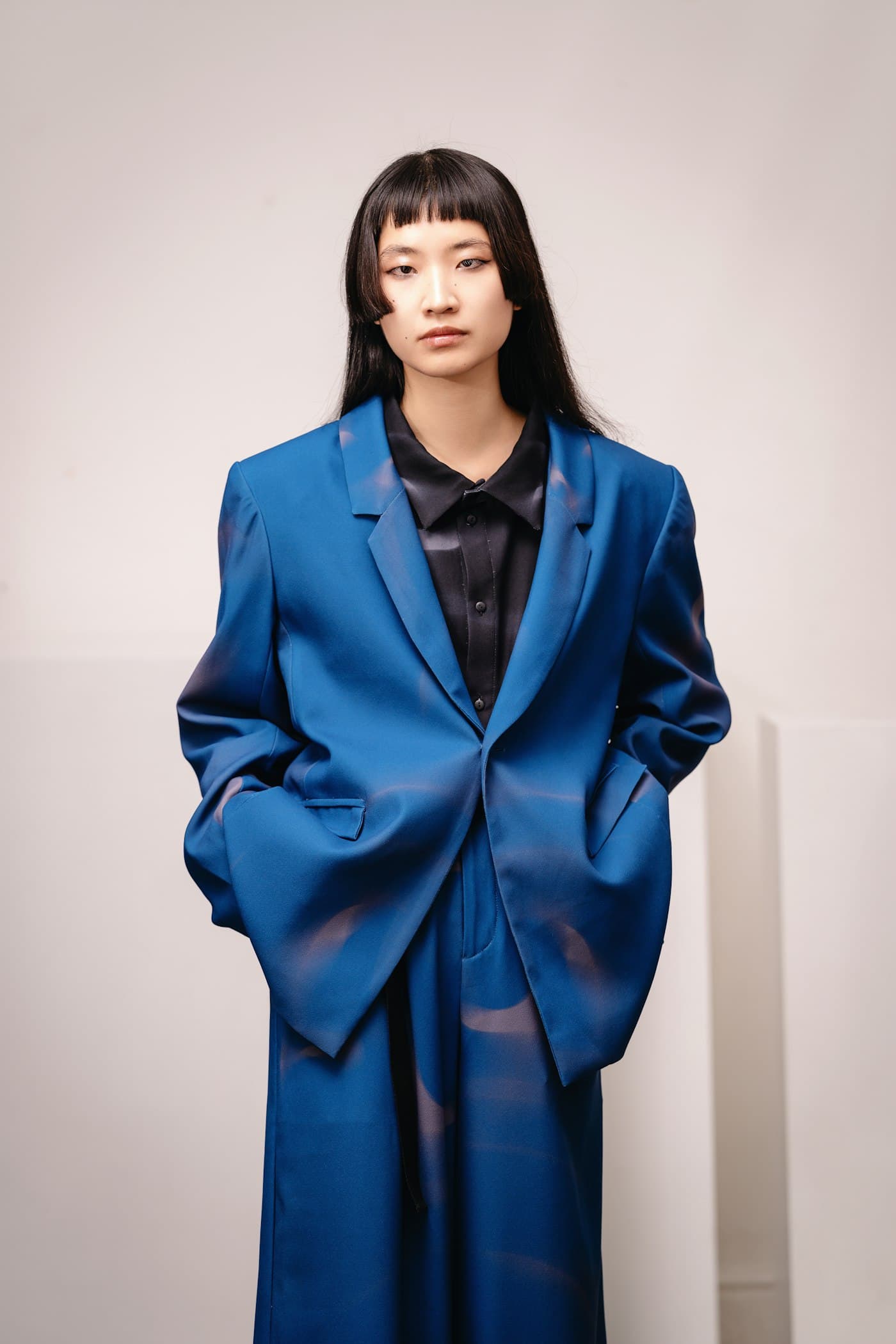 Travel-ready layered outfit with jacket and wide-leg trouser.